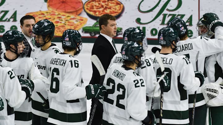 MSU hockey coach Adam Nightingale and his Spartans gather on the ice following MSU's 4-3 win over Notre Dame, Saturday, Nov. 15, 2024.