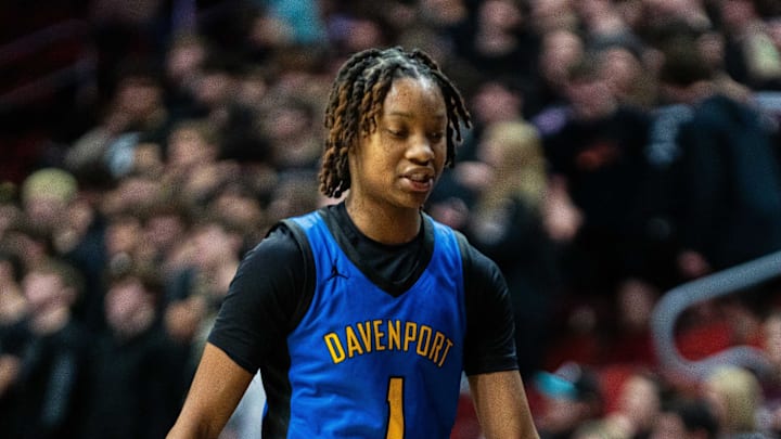 Davenport North's Divine Bourrage (1) high fives her teammates as she's subbed out during the third quarter of the Class 5A quarterfinal on Monday, March 3, 2025, at Wells Fargo Arena. Davenport North's Divine Bourrage (1) high fives her teammates as she's subbed out during the third quarter of the Class 5A quarterfinal on Monday, March 3, 2025, at Wells Fargo Arena.