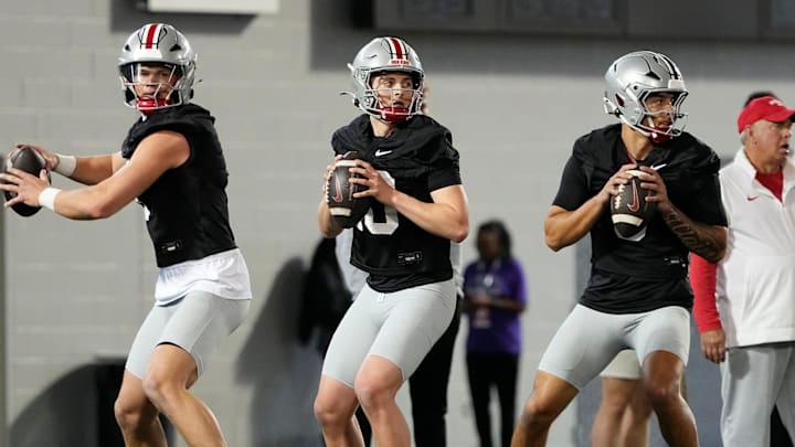 From left, Ohio State Buckeyes quarterbacks Lincoln Kienholz (3), Julian Sayin (10) and Tavien St. Clair (9) drop back to pass during spring football practice at the Woody Hayes Athletic Center in Columbus on March 19, 2025. From left, Ohio State Buckeyes quarterbacks Lincoln Kienholz (3), Julian Sayin (10) and Tavien St. Clair (9) drop back to pass during spring football practice at the Woody Hayes Athletic Center in Columbus on March 19, 2025.