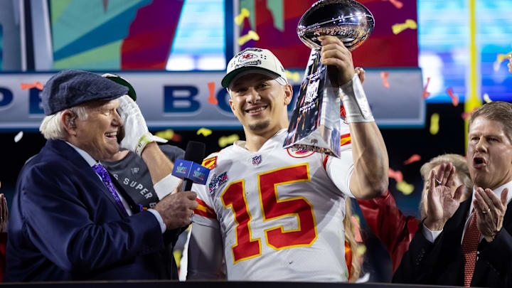 Feb 12, 2023; Glendale, Arizona, US; Kansas City Chiefs quarterback Patrick Mahomes (15) celebrates with the Vince Lombardi Trophy alongside Fox host Terry Bradshaw after defeating the Philadelphia Eagles during Super Bowl LVII at State Farm Stadium. Mandatory Credit: Mark J. Rebilas-Imagn Images