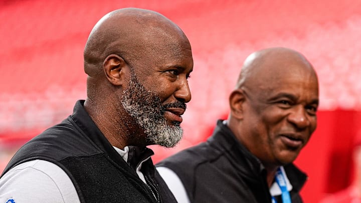 Detroit Lions general manager Brad Holmes, left, and assistant general manager Ray Agnew walk off the field