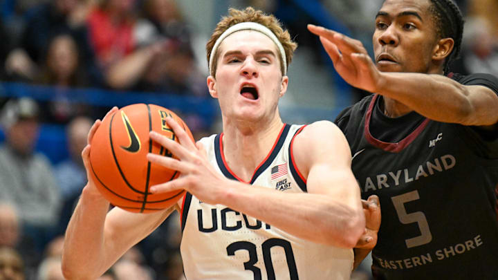 Nov 30, 2024; Storrs, Connecticut, USA; Connecticut Huskies forward Liam McNeeley (30) drives to the basket against Maryland Eastern Shore guard Cardell Bailey (5) during the second half at XL Center. Mandatory Credit: Mark Smith-Imagn Images
