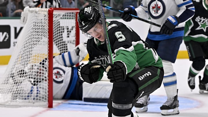 Feb 2, 2026; Dallas, Texas, USA; Dallas Stars defenseman Nils Lundkvist (5) celebrates after he scores a goal against Winnipeg Jets goaltender Connor Hellebuyck (37) during the second period at the American Airlines Center. Mandatory Credit: Jerome Miron-Imagn Images