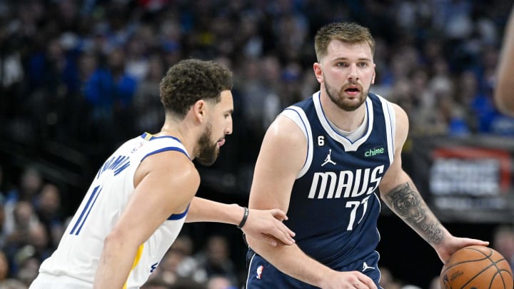 Mar 22, 2023; Dallas, Texas, USA; Golden State Warriors guard Klay Thompson (11) and Dallas Mavericks guard Luka Doncic (77) in action during the game between the Dallas Mavericks and the Golden State Warriors at the American Airlines Center. Mandatory Credit: Jerome Miron-USA TODAY Sports