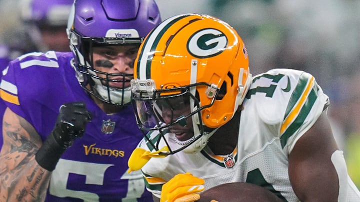 Green Bay Packers wide receiver Jayden Reed (11) runs after the catch against Minnesota Vikings linebacker Blake Cashman.