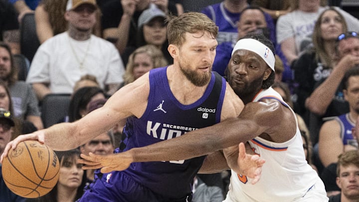 March 16, 2024; Sacramento, California, USA; Sacramento Kings forward Domantas Sabonis (10) dribbles the basketball against New York Knicks forward Precious Achiuwa (5) during the second quarter at Golden 1 Center. Mandatory Credit: Kyle Terada-Imagn Images