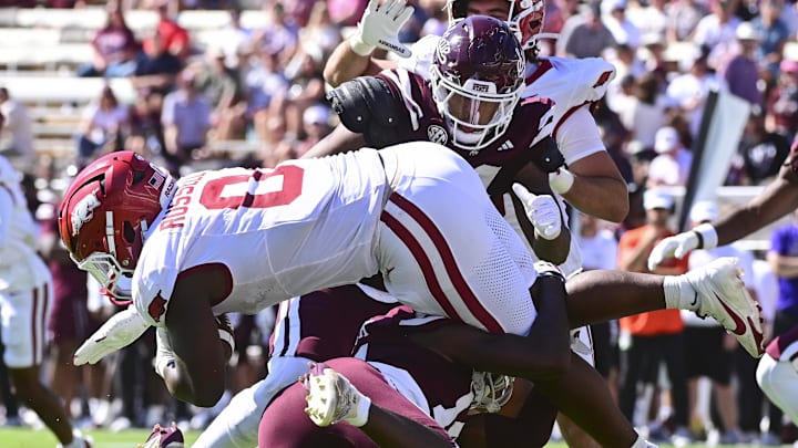 Arkansas Razorbacks running back Braylen Russell (0) is tackled by Mississippi State Bulldogs cornerback Brice Pollock (14) during the second quarter at Davis Wade Stadium at Scott Field.