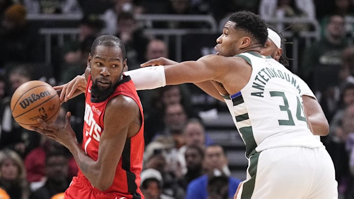 Nov 9, 2025; Milwaukee, Wisconsin, USA; Milwaukee Bucks forward Giannis Antetokounmpo (34) attempts to strip the ball from Houston Rockets forward Kevin Durant (7) in the second half at Fiserv Forum. Mandatory Credit: Michael McLoone-Imagn Images