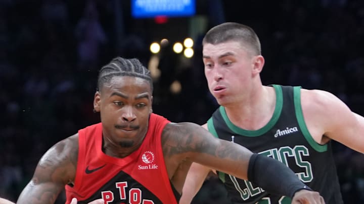 Toronto Raptors guard Jamal Shead dribbles the ball against Boston Celtics guard Payton Pritchard.
