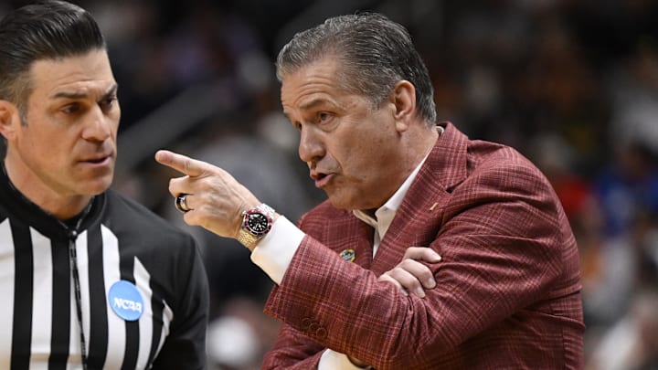 Arkansas Razorbacks head coach John Calipari talks to a referee against the Arizona Wildcats in the first half during a Sweet Sixteen game of the West Regional of the NCAA Tournament at SAP Center.