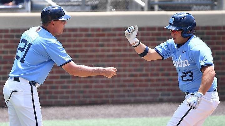 North Carolina Head Coach Scott Forbes (21) congratulates Sam Angelo (23) as he rounds third base after hitting a two-run homer against Arizona in the top of the second inning. The North Carolina Tar Heels and the Arizona Wildcats met in game two of the NCAA Division 1 Super Regionals in Chapel Hill, N.C. on June 7, 2025. North Carolina Head Coach Scott Forbes (21) congratulates Sam Angelo (23) as he rounds third base after hitting a two-run homer against Arizona in the top of the second inning. The North Carolina Tar Heels and the Arizona Wildcats met in game two of the NCAA Division 1 Super Regionals in Chapel Hill, N.C. on June 7, 2025.