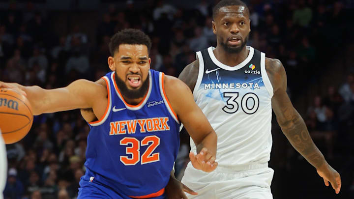 Dec 19, 2024; Minneapolis, Minnesota, USA; New York Knicks forward Karl-Anthony Towns (32) works around Minnesota Timberwolves forward Julius Randle (30) in the first quarter at Target Center.