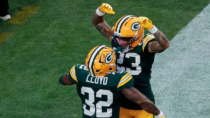 Green Bay Packers running back Marshawn Lloyd (32) celebrates his touchdown with wide receiver Skyy Moore.