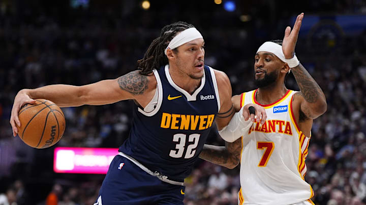 Jan 9, 2026; Denver, Colorado, USA; Atlanta Hawks guard Nickeil Alexander-Walker (7) defends on Denver Nuggets forward Aaron Gordon (32) in the second quarter at Ball Arena.
