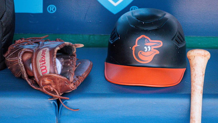 Apr 21, 2024; Kansas City, Missouri, USA; Baltimore Orioles hat and glove sits in the dugout during the ninth inning against the Kansas City Royals at Kauffman Stadium. Mandatory Credit: William Purnell-Imagn Images