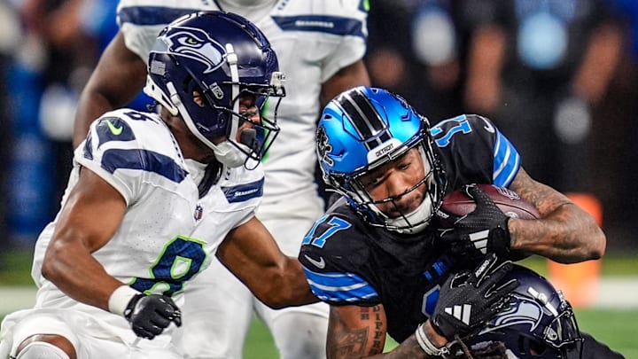 Detroit Lions wide receiver Tim Patrick (17) catches a pass against Seattle Seahawks safety Rayshawn Jenkins (2) and Seattle Seahawks cornerback Coby Bryant (8) during the second half of the N.F.L. game at Ford Field in Detroit, Tuesday, Oct. 1, 2024.
