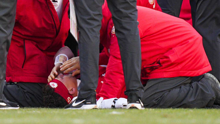 Dec 14, 2025; Kansas City, Missouri, USA; Kansas City Chiefs quarterback Patrick Mahomes (15) is attended to by team medical staff following an injury during the fourth quarter against the Los Angeles Chargers at GEHA Field at Arrowhead Stadium. Mandatory Credit: Jay Biggerstaff-Imagn Images Dec 14, 2025; Kansas City, Missouri, USA; Kansas City Chiefs quarterback Patrick Mahomes (15) is attended to by team medical staff following an injury during the fourth quarter against the Los Angeles Chargers at GEHA Field at Arrowhead Stadium. Mandatory Credit: Jay Biggerstaff-Imagn Images