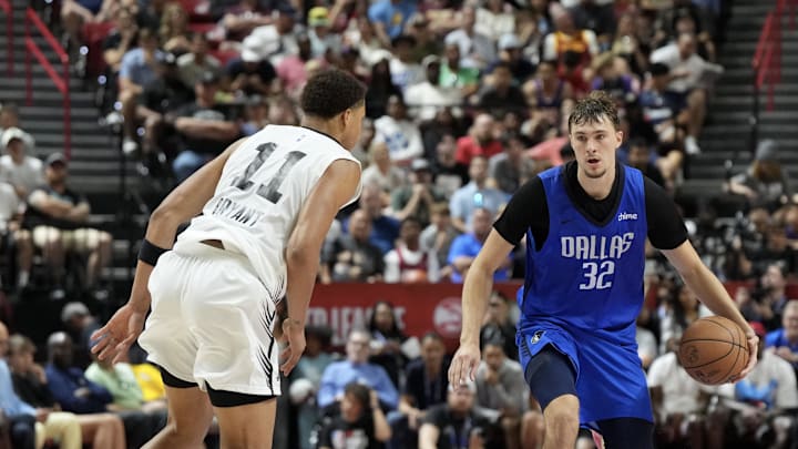 Dallas Mavericks forward Cooper Flagg dribbles against San Antonio Spurs forward Carter Bryant.