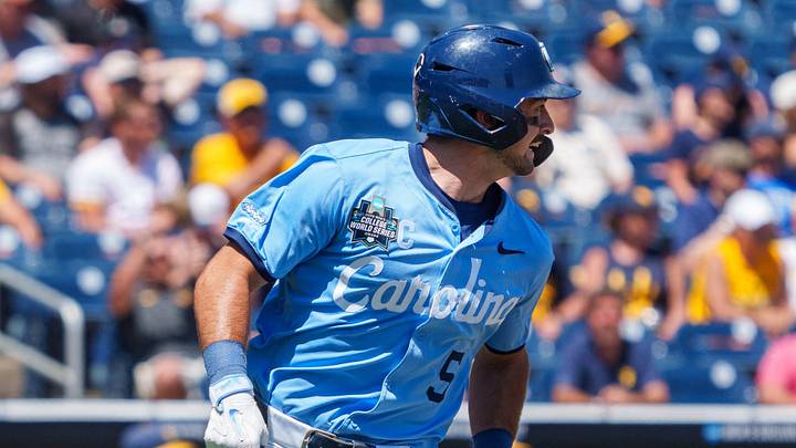 Jun 17, 2026; Omaha, NE, USA; North Carolina Tar Heels second baseman Gavin Gallaher (5) runs to first as designated hitter Macon Winslow (6) scores against the West Virginia Mountaineers during the sixth inning at Charles Schwab Field. Mandatory Credit: Dylan Widger-Imagn Images Jun 17, 2026; Omaha, NE, USA; North Carolina Tar Heels second baseman Gavin Gallaher (5) runs to first as designated hitter Macon Winslow (6) scores against the West Virginia Mountaineers during the sixth inning at Charles Schwab Field. Mandatory Credit: Dylan Widger-Imagn Images