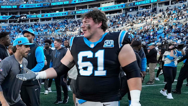 Nov 3, 2024; Charlotte, North Carolina, USA; Carolina Panthers guard Brady Christensen (70) and offensive tackle Jarrett Kingston (61) celebrate after the game at Bank of America Stadium. Mandatory Credit: Bob Donnan-Imagn Images