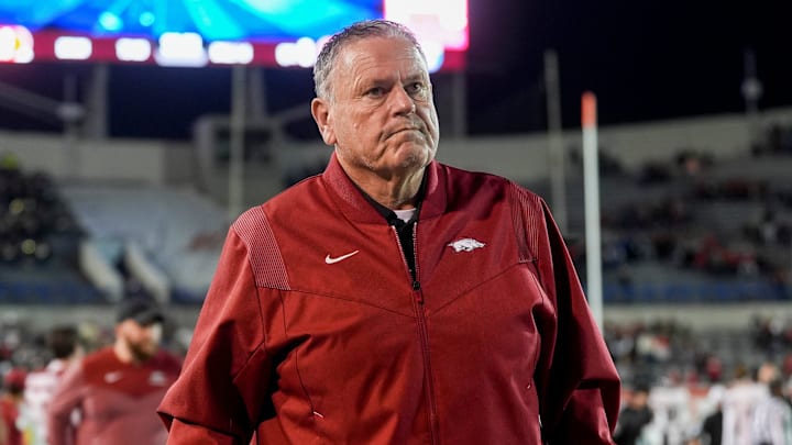 Arkansas' head coach Sam Pittman walks down the sideline assisted by a cane as both teams warm up before the AutoZone Liberty Bowl kicks off between Arkansas and Texas Tech in Memphis, Tenn., on Friday, December 27, 2024.