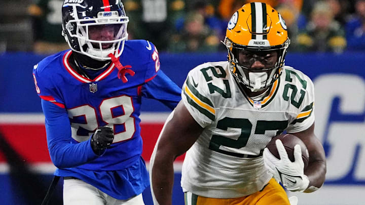 Former Green Bay Packers running back Patrick Taylor (27) runs the ball against New York Giants cornerback Cor'Dale Flott (28) during the second quarter at MetLife Stadium.