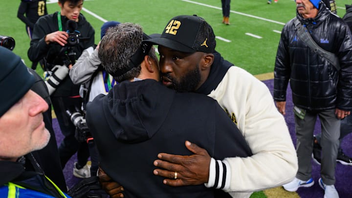 Nov 15, 2024; Seattle, Washington, USA; Washington Huskies head coach Jedd Fisch and UCLA Bruins head coach DeShaun Foster greet each other after the game at Alaska Airlines Field at Husky Stadium. Mandatory Credit: Steven Bisig-Imagn Images
