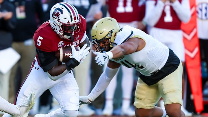 Nov 23, 2024; Columbia, South Carolina, USA; South Carolina Gamecocks running back Raheim Sanders (5) runs the ball against Wofford Terriers defensive back Javis Mynatt (11) in the first quarter at Williams-Brice Stadium. Nov 23, 2024; Columbia, South Carolina, USA; South Carolina Gamecocks running back Raheim Sanders (5) runs the ball against Wofford Terriers defensive back Javis Mynatt (11) in the first quarter at Williams-Brice Stadium.