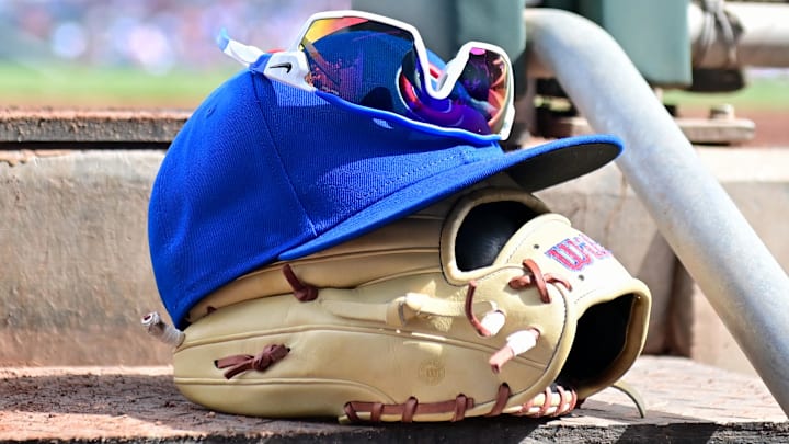 Feb 27, 2024; Mesa, Arizona, USA;  General view of a Chicago Cubs glove, hat and glasses in the first inning against the Cincinnati Reds during a spring training game at Sloan Park.