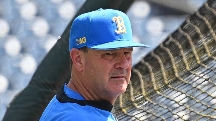 Jun 14, 2025; Omaha, Neb, USA; UCLA Bruins head coach John Savage watches the team warm up before the game against the Murray State Races at Charles Schwab Field. Mandatory Credit: Steven Branscombe-Imagn Images Jun 14, 2025; Omaha, Neb, USA; UCLA Bruins head coach John Savage watches the team warm up before the game against the Murray State Races at Charles Schwab Field. Mandatory Credit: Steven Branscombe-Imagn Images