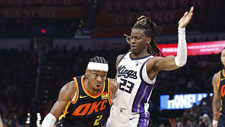 Feb 11, 2024; Oklahoma City, Oklahoma, USA;Oklahoma City Thunder guard Shai Gilgeous-Alexander (2) moves around Sacramento Kings guard Keon Ellis (23) during the second half at Paycom Center. Mandatory Credit: Alonzo Adams-Imagn Images