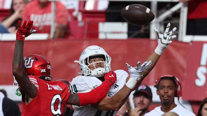 Sep 6, 2025; Salt Lake City, Utah, USA; Utah Utes cornerback Elijah Davis (9) and Cal Poly Mustangs wide receiver Michael Briscoe (10) battle for a pass during the second quarter at Rice-Eccles Stadium. Mandatory Credit: Rob Gray-Imagn Images