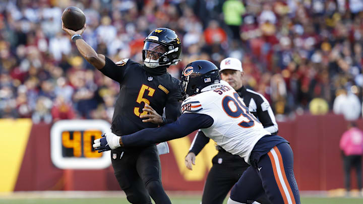 Quarterback Jayden Daniels tries to unload the ball before Montez Sweat can unload on him.