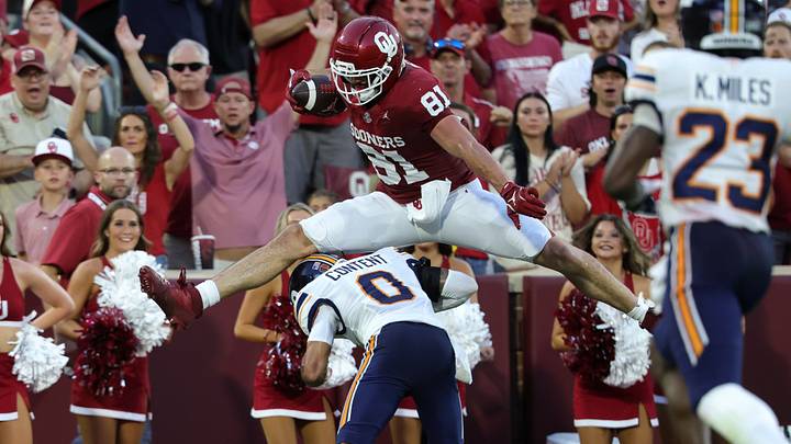 Oklahoma tight end Rocky Beers (81) hurdles over Texas El Paso Miners cornerback Justin Content (0) on his way to a 40-yard touchdown.