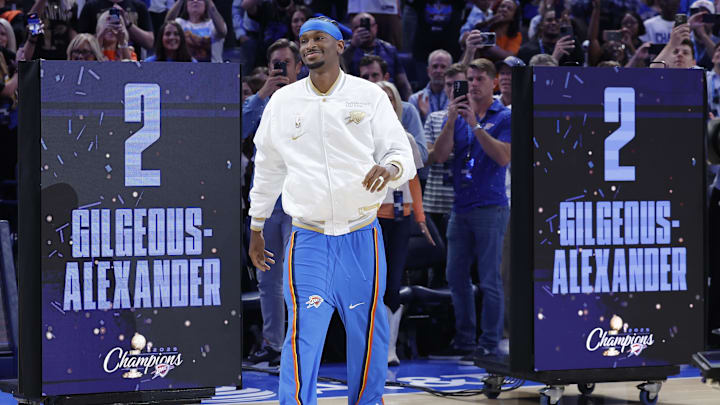 Oct 21, 2025; Oklahoma City, Oklahoma, USA; Oklahoma City Thunder guard Shai Gilgeous-Alexander walks onto the court during the championship ring and banner ceremony before the start of their game against the Houston Rockets at Paycom Center. Mandatory Credit: Alonzo Adams-Imagn Images