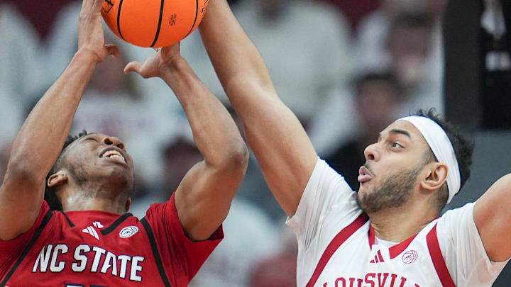 Louisville Cardinals center Aly Khalifa (15) blocks the shot of NC State Wolfpack guard Quadir Copeland (11) but was called for the foul in the first half at the KFC Yum! Center in downtown Louisville February 9, 2026.