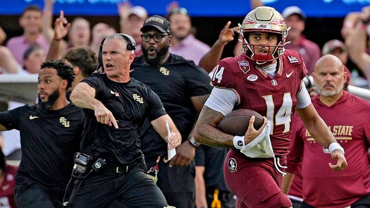 Oct 3, 2026; Tallahassee, Florida, USA; Florida State Seminoles quarterback Ashton Daniels (14) runs for a touchdown as head coach Mike Norvell cheers on the sidelines during the second half against the Virginia Cavaliers at Doak S. Campbell Stadium. Mandatory Credit: Melina Myers-Imagn Images Oct 3, 2026; Tallahassee, Florida, USA; Florida State Seminoles quarterback Ashton Daniels (14) runs for a touchdown as head coach Mike Norvell cheers on the sidelines during the second half against the Virginia Cavaliers at Doak S. Campbell Stadium. Mandatory Credit: Melina Myers-Imagn Images