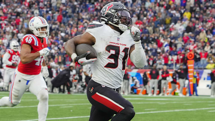 Oct 13, 2024; Foxborough, Massachusetts, USA; Houston Texans running back Dameon Pierce (31) runs with the ball for a touchdown against the New England Patriots during the second half at Gillette Stadium. 