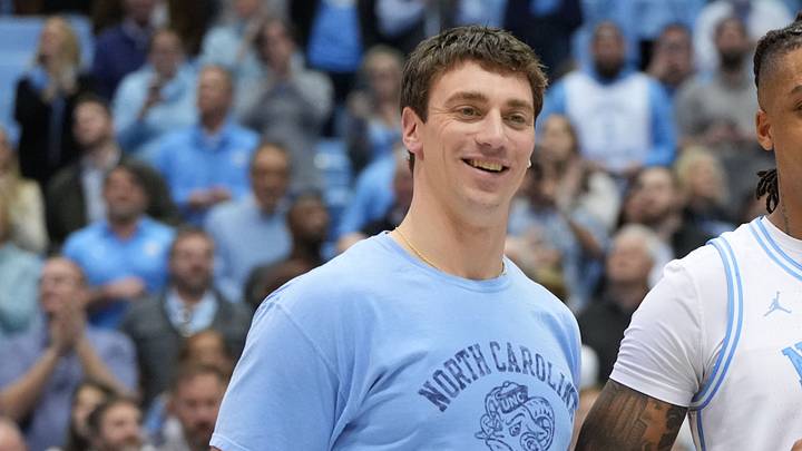 Jan 21, 2023; Chapel Hill, North Carolina, USA; Former North Carolina Tar Heels great Tyler Hansbrough presents forward Armando Bacot (5) with the game ball after the game. Bacot became the all-time Tar Heels rebounding leader during the game breaking Hansbrough’s record. Mandatory Credit: Bob Donnan-USA TODAY Sports
