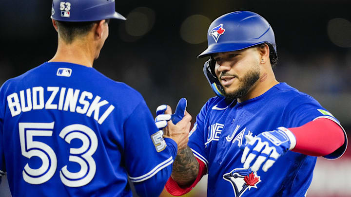 Apr 26, 2026; Toronto, Ontario, CAN; Toronto Blue Jays left fielder Yohendrick Pinango (24) celebrates hitting his first single against the Cleveland Guardians during the fifth inning with first base coach Mark Budzinski (53) at Rogers Centre. Mandatory Credit: Kevin Sousa-Imagn Images