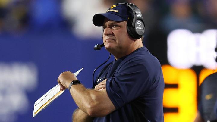 Oct 3, 2025; Provo, Utah, USA; West Virginia Mountaineers head coach Rich Rodriguez looks on during the first quarter of the game against the Brigham Young Cougars at LaVell Edwards Stadium. Mandatory Credit: Rob Gray-Imagn Images Oct 3, 2025; Provo, Utah, USA; West Virginia Mountaineers head coach Rich Rodriguez looks on during the first quarter of the game against the Brigham Young Cougars at LaVell Edwards Stadium. Mandatory Credit: Rob Gray-Imagn Images