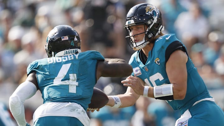 Oct 27, 2024; Jacksonville, Florida, USA; Jacksonville Jaguars quarterback Trevor Lawrence (16) hands the ball off to running back Tank Bigsby (4) against the Green Bay Packers during the third quarter at EverBank Stadium. Mandatory Credit: Morgan Tencza-Imagn Images
