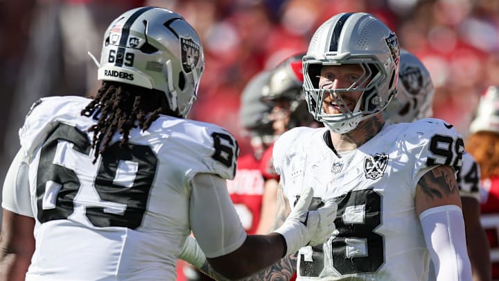 Dec 8, 2024; Tampa, Florida, USA; Las Vegas Raiders defensive end Maxx Crosby (98) and defensive tackle Adam Butler (69) reacts after a play against the Tampa Bay Buccaneers in the second quarter at Raymond James Stadium. Mandatory Credit: Nathan Ray Seebeck-Imagn Images