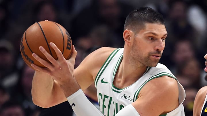 Feb 25, 2026; Denver, Colorado, USA; Boston Celtics center Nikola Vucevic (4) works in the post against Denver Nuggets guard Julian Strawther (3) during the first half at Ball Arena. Mandatory Credit: Christopher Hanewinckel-Imagn Images