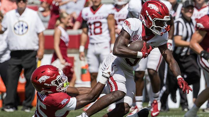 Arkansas Razorbacks wide receiver Jamari Hawkins (9) tries to escape the grasp of defensive back Nsongbeh Ginyui (15) during the spring game at Razorback Stadium. Arkansas Razorbacks wide receiver Jamari Hawkins (9) tries to escape the grasp of defensive back Nsongbeh Ginyui (15) during the spring game at Razorback Stadium.