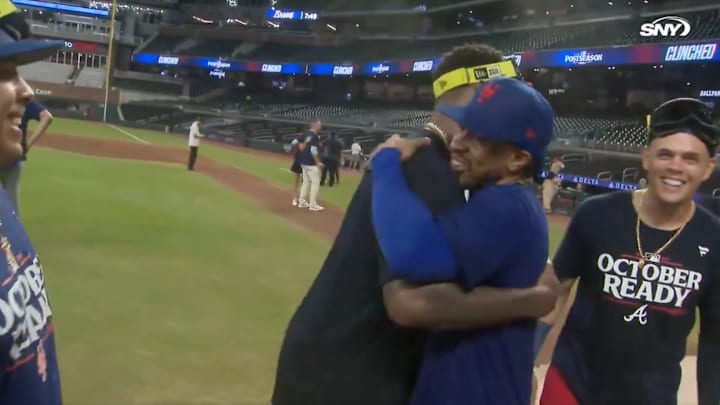 Mets and Braves players celebrate together.