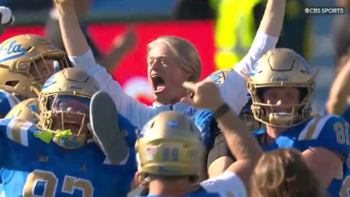 UCLA players carry offensive play-caller Jerry Neuheisel off the field after the team's upset win over Penn State.