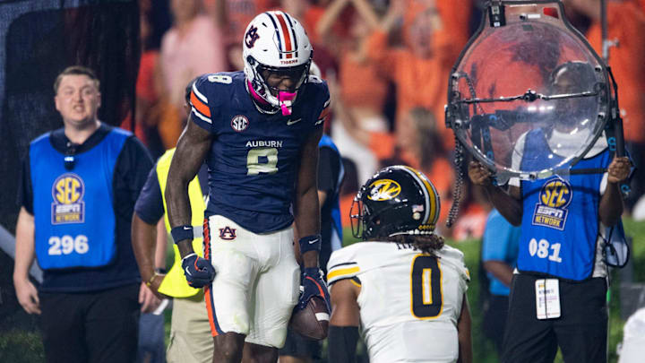 Auburn Tigers wide receiver Cam Coleman celebrates his catch over Missouri Tigers defensive back Stephen Hall.