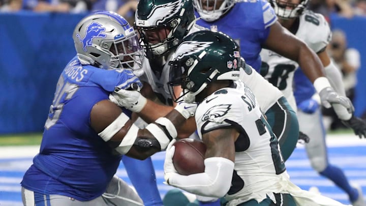 Former Detroit Lions defensive lineman Isaiah Buggs (96) tries to tackle Philadelphia Eagles running back Miles Sanders (26) 
