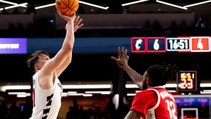Cincinnati Bearcats guard-forward Simas Lukošius (41) hits a 3-point shot as Ohio State Buckeyes guard Evan Mahaffey (12) guards him in the first half of a basketball scrimmage between Cincinnati Bearcats and Ohio State Buckeyes at Fifth Third Arena in Cincinnati on Friday, Oct. 18, 2024. Cincinnati Bearcats guard-forward Simas Lukošius (41) hits a 3-point shot as Ohio State Buckeyes guard Evan Mahaffey (12) guards him in the first half of a basketball scrimmage between Cincinnati Bearcats and Ohio State Buckeyes at Fifth Third Arena in Cincinnati on Friday, Oct. 18, 2024.